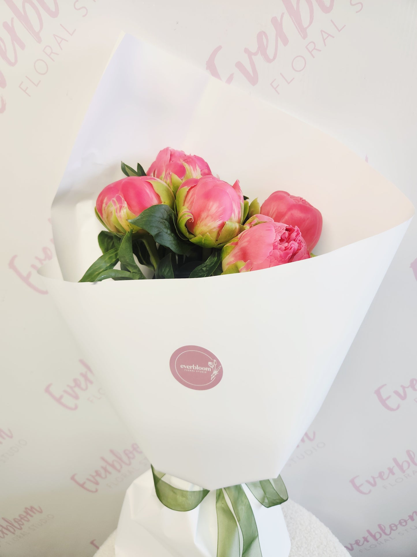 Peony roses wrapped in white paper with a bow. Tauranga flower delivery. Everbloom Floral Studio. Welcome Bay Florist