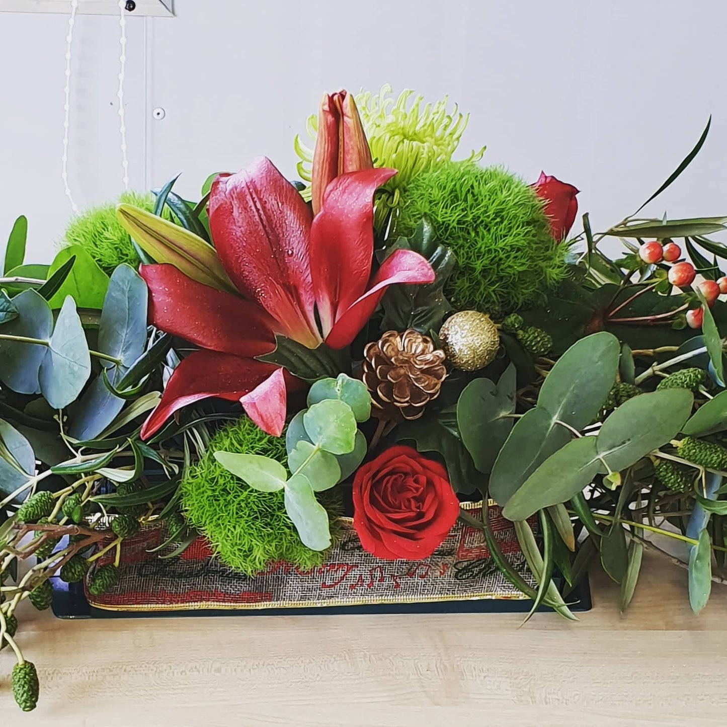 Christmas Table Arrangement - Red, Green and White in a variety of seasonal flowers .
Everbloom Floral Studio Tauranga Florist