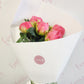Peony roses wrapped in white paper with a bow. Tauranga flower delivery. Everbloom Floral Studio. Welcome Bay Florist