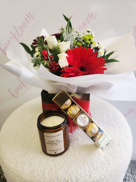 Christmas gift of flowers in a box a christmas scented candle and chocolates from your favourite Tauranga florist