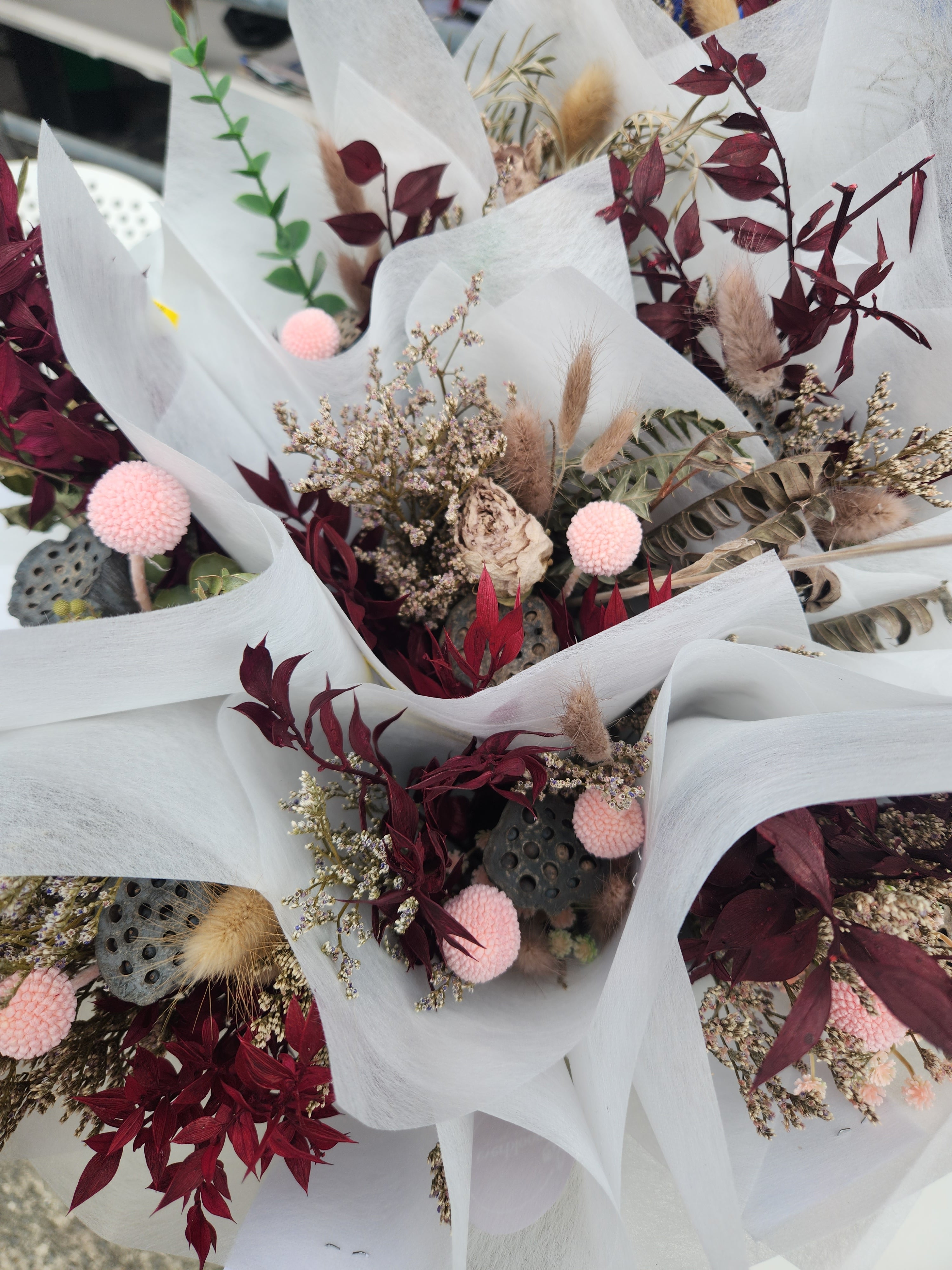 Bouquet of dried flowers in raspberry and pink tones created by mel at everbloom floral studio, one of Tauranga's leading florists