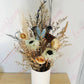 Our dried flower arrangements now come in white vases, Simply receive, display and enjoy, no fuss finding the right height vase for your flowers.  Dried arrangements may slightly vary due to availability and colour but for the most part will stay similar to the pictures provided.  A mix of strawflowers, caspea, spray roses, anenomes, lotus pods and wild flowers.  Same day flower delivery from our sunny mount maunganui floral studio.