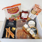 New to our Menu is this snackers delight gift box, packed with delicious nibbles to share with your friends and family. A great picnic pack or pre BBQ platter.  Gift Box includes -   Proper Crisps Garden Medley Chips, Barkers Sundried Tomato and Olive Chutney, Wafers, Cheese Straws, Semi Dried Apricots, Almonds, Black Cherry and Pinot Noir Jelly, Waitemata Cheese and a pack of Fererro Rochers.  Order for your same day hamper and gift box delivery to Papamoa, Mount Maunganui and Tauranga 