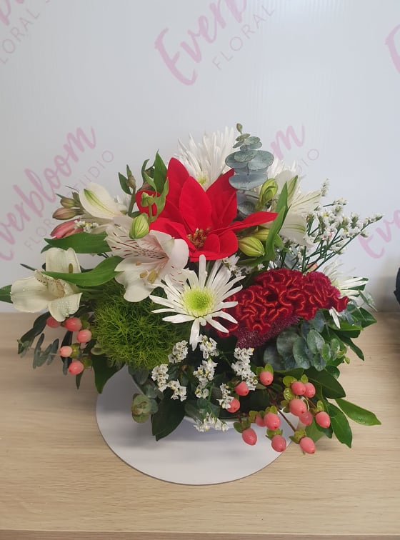 Christmas table arrangement - Made with a mix of fresh seasonal flowers in  Christmas colours.
Everbloom Floral Studio - Local Mount Maunganui and Papamoa Florist
