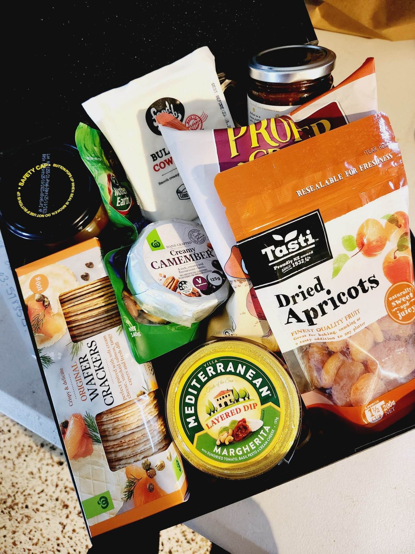 New to our Menu is this snackers delight gift box, packed with delicious nibbles to share with your friends and family. A great picnic pack or pre BBQ platter. Gift Box includes - Proper Crisps Garden Medley Chips, Barkers Sundried Tomato and Olive Chutney, Wafers, Cheese Straws, Semi Dried Apricots, Almonds, Black Cherry and Pinot Noir Jelly, Waitemata Cheese and a pack of Fererro Rochers. Order for your same day hamper and gift box delivery to Papamoa, Mount Maunganui and Tauranga