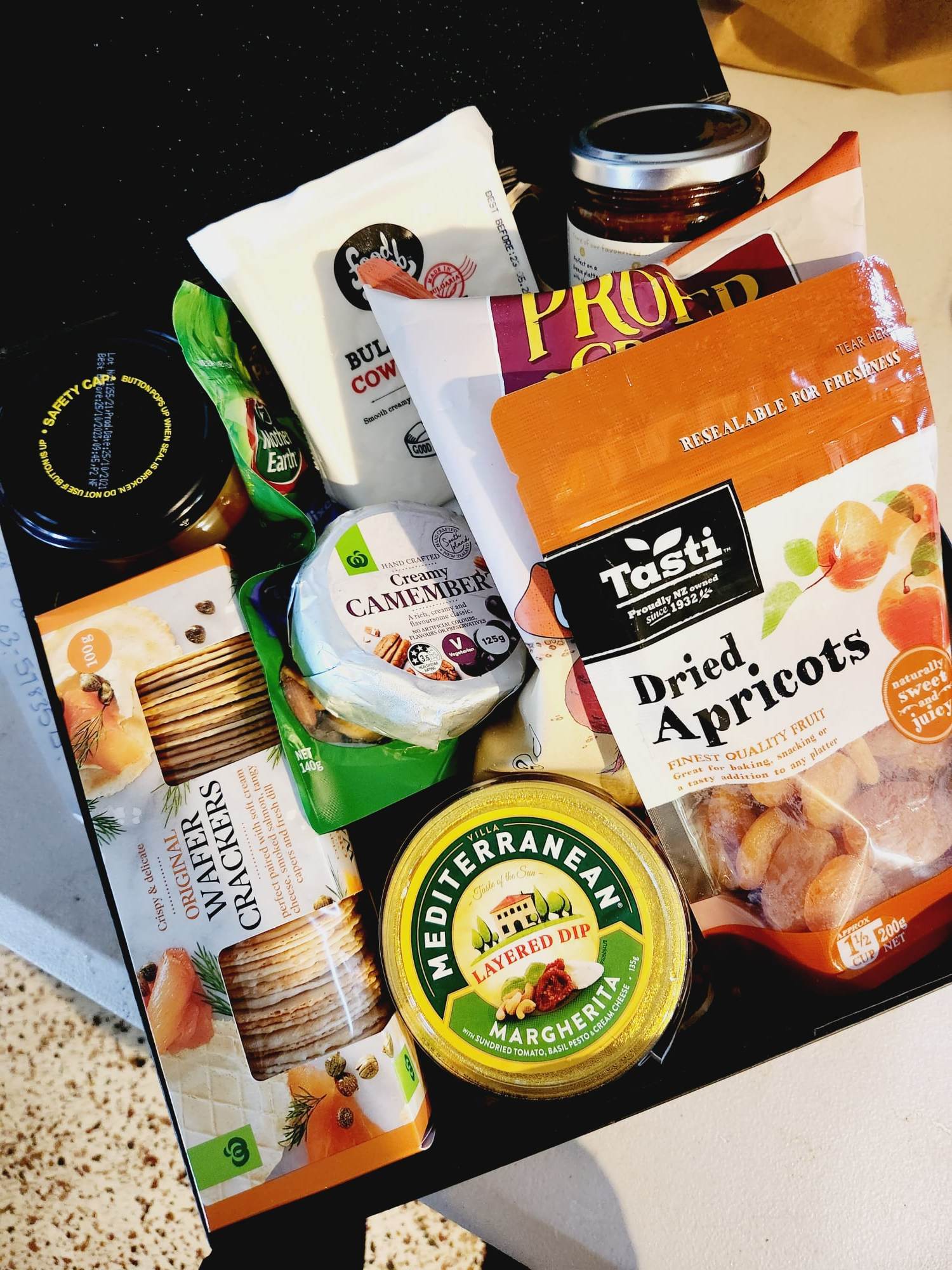 New to our Menu is this snackers delight gift box, packed with delicious nibbles to share with your friends and family. A great picnic pack or pre BBQ platter. Gift Box includes - Proper Crisps Garden Medley Chips, Barkers Sundried Tomato and Olive Chutney, Wafers, Cheese Straws, Semi Dried Apricots, Almonds, Black Cherry and Pinot Noir Jelly, Waitemata Cheese and a pack of Fererro Rochers. Order for your same day hamper and gift box delivery to Papamoa, Mount Maunganui and Tauranga